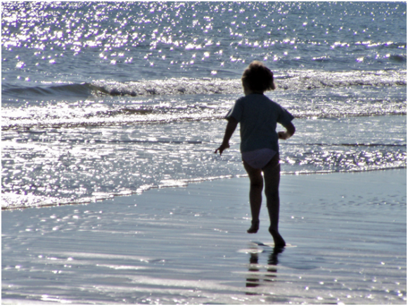 Child playing, Bibione beach ( creative commons)